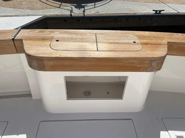  Yacht Photos Pics 2004 Cabo 35 Express boat with wooden deck and storage compartment.