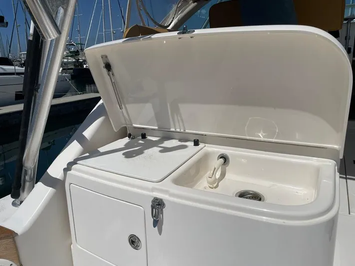  Yacht Photos Pics 2004 Cabo 35 Express boat sink and storage area with open lid.