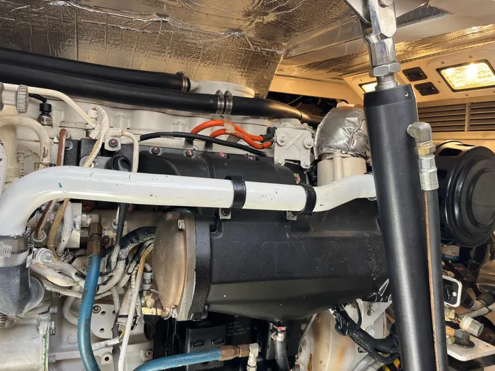  Yacht Photos Pics Engine compartment of a 2004 Cabo 35 Express boat, showcasing detailed mechanical components.