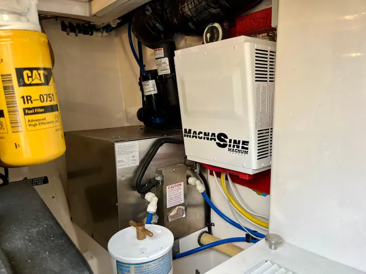  Yacht Photos Pics Engine room of 2004 Cabo 35 Express with fuel filter and Magnum inverter.