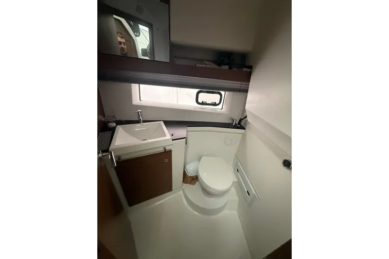  Yacht Photos Pics 2019 Jeanneau NC 9 boat bathroom with sink, toilet, and window.