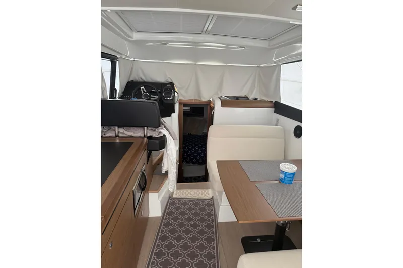  Yacht Photos Pics Interior of 2019 Jeanneau NC 9 boat with modern seating and helm station.