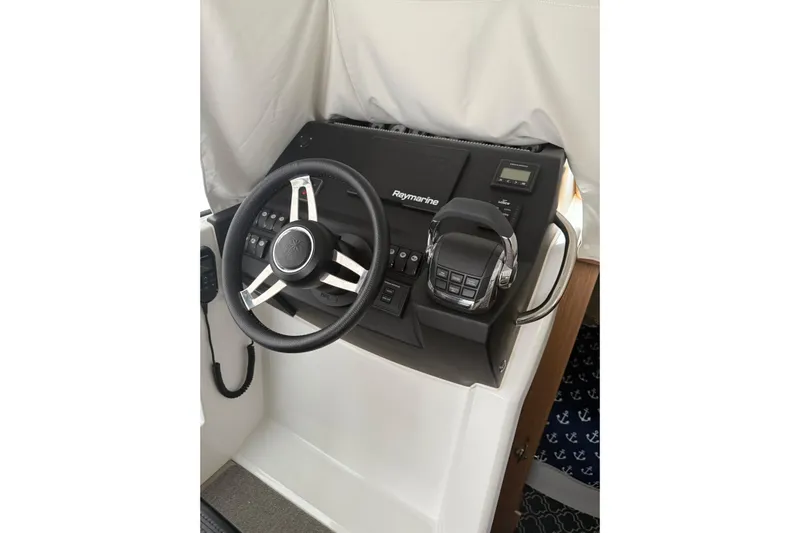  Yacht Photos Pics 2019 Jeanneau NC 9 helm with Raymarine controls and steering wheel.