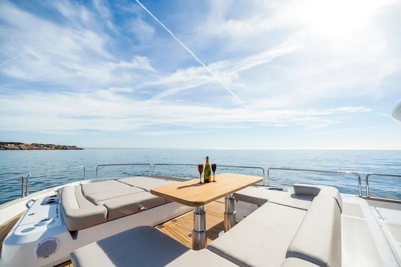 Salacia Yacht Photos Pics Luxurious 2019 Sirena 64 yacht deck with seating, table, and ocean view.