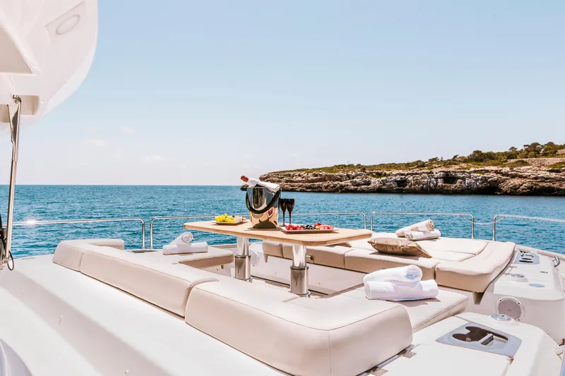 Salacia Yacht Photos Pics Luxurious Sirena 64 yacht deck with sun loungers, table, and ocean view, 2019 model.