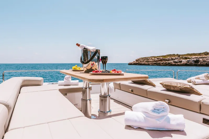 Salacia Yacht Photos Pics Luxurious Sirena 64 yacht deck with champagne, fruit, and ocean view, 2019 model.