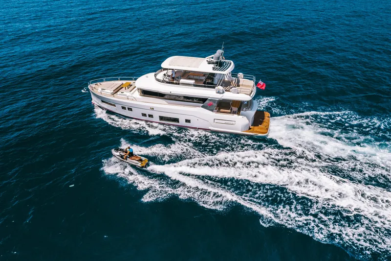 Salacia Yacht Photos Pics Aerial view of 2019 Sirena 64 yacht cruising with a jet ski nearby.