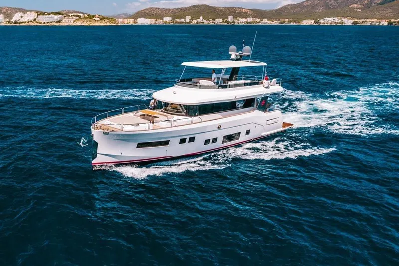 Salacia Yacht Photos Pics 2019 Sirena 64 yacht cruising on blue ocean near coastline.