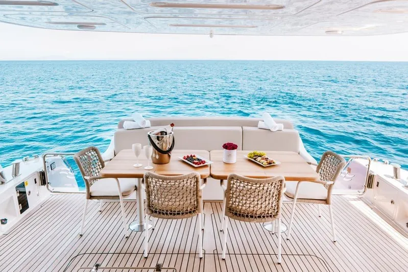Salacia Yacht Photos Pics Luxurious Sirena 64 yacht deck with dining setup overlooking the ocean, 2019 model.