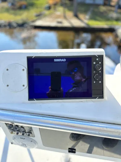 Bad Habit Yacht Photos Pics Simrad marine display on 1997 Viking 43 Open boat, reflecting surroundings.