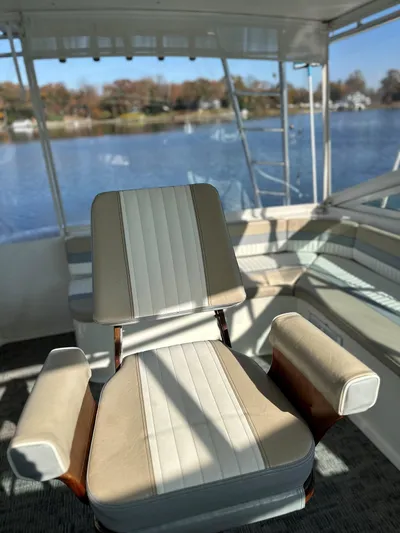 Bad Habit Yacht Photos Pics Captain's chair on 1997 Viking 43 Open yacht, overlooking serene waters.