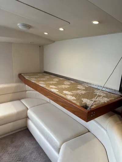 Bad Habit Yacht Photos Pics Interior of 1997 Viking 43 Open yacht with white leather seating and fold-down bed.