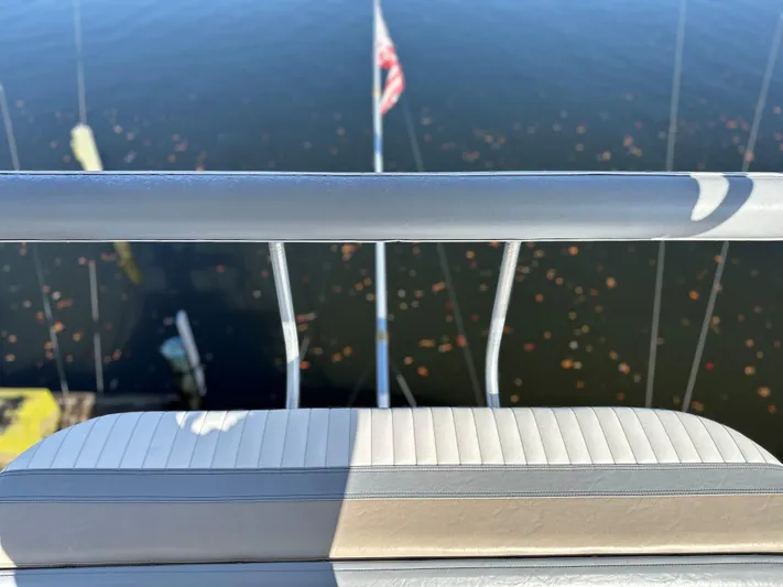 Bad Habit Yacht Photos Pics View from 1997 Viking 43 Open boat, overlooking calm water and American flag.