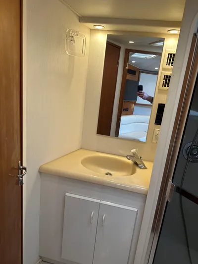 Bad Habit Yacht Photos Pics Bathroom vanity in 1997 Viking 43 Open yacht, featuring sink and mirror.