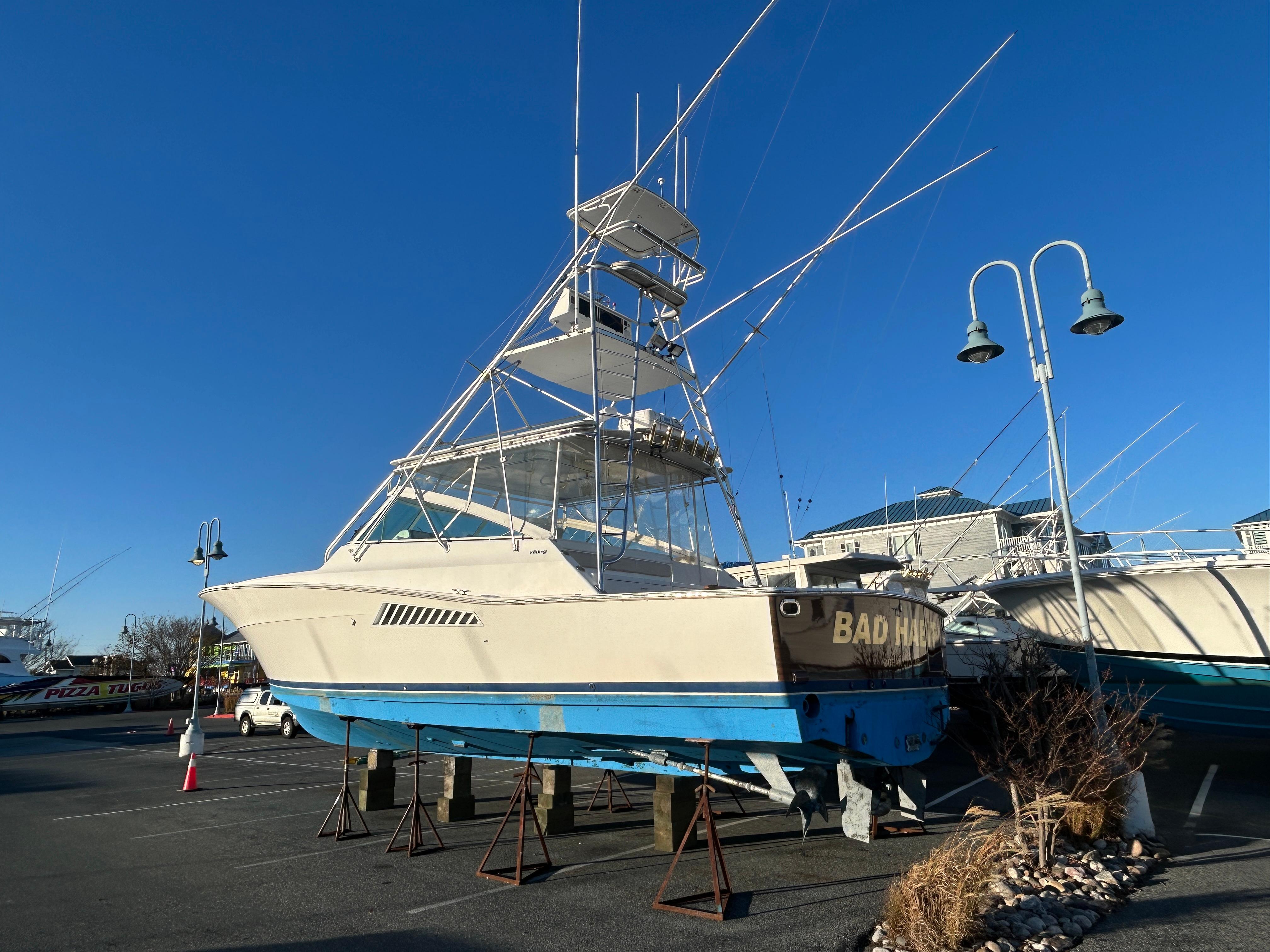 1997 Viking 43 Open boat on stands, clear blue sky background.