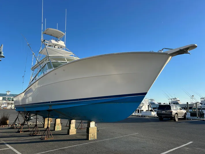 Bad Habit Yacht Photos Pics 1997 Viking 43 Open yacht on stands in a marina parking lot.