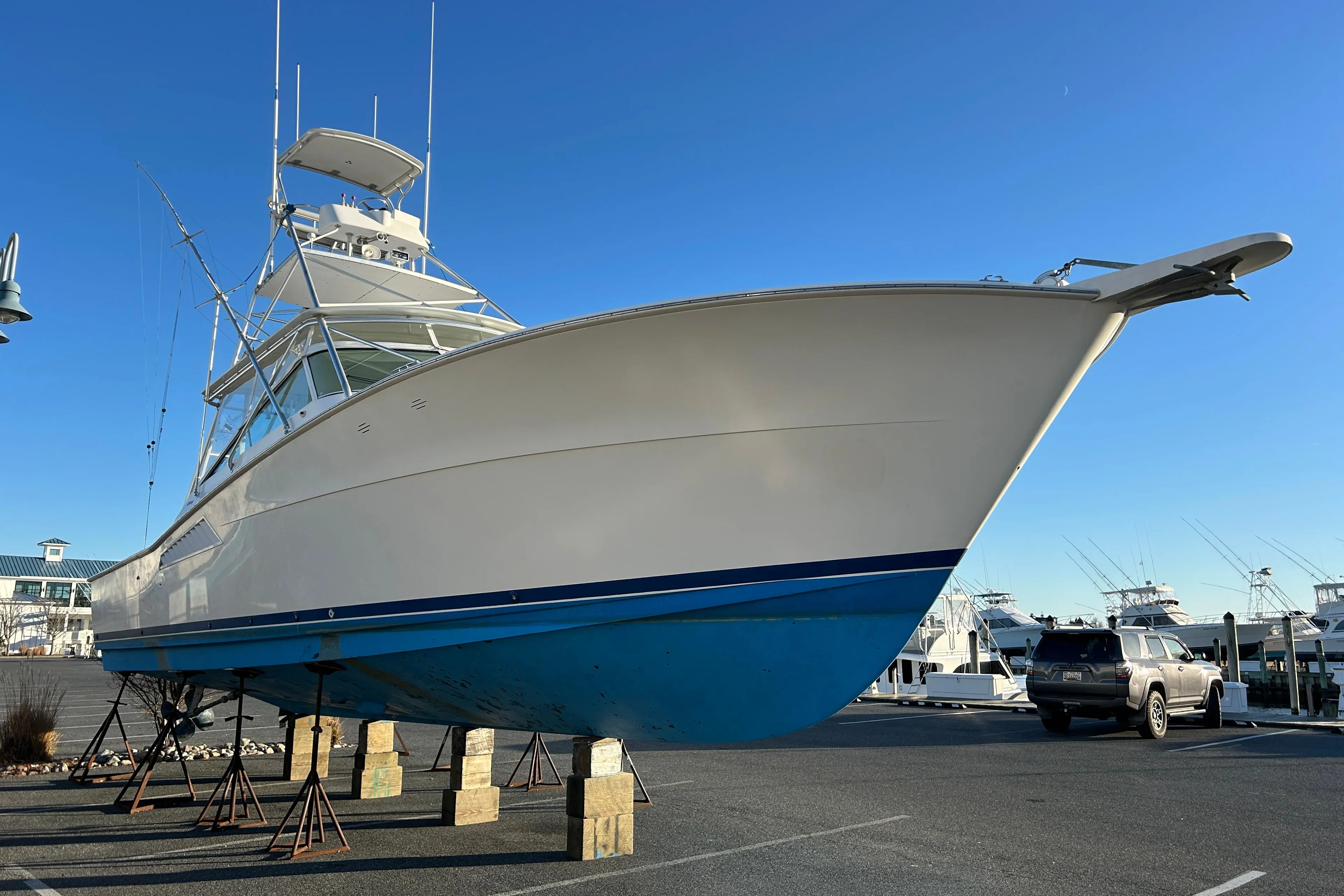 1997 Viking 43 Open yacht on stands in a marina parking lot.
