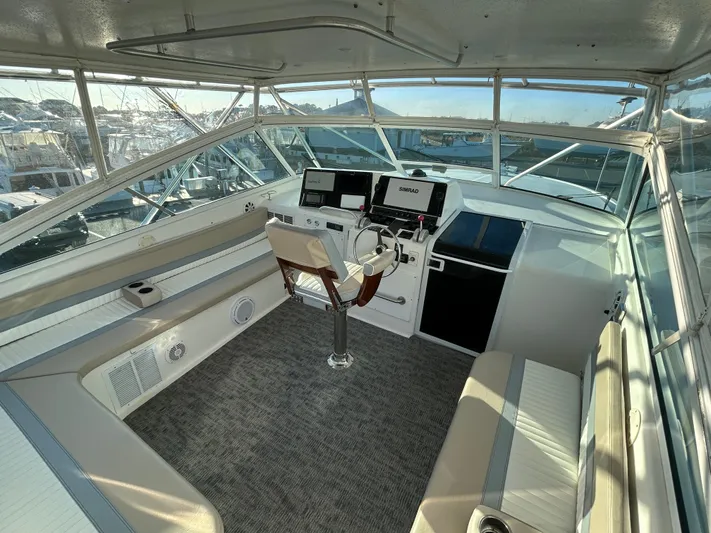 Bad Habit Yacht Photos Pics 1997 Viking 43 Open yacht helm with modern navigation equipment and seating.