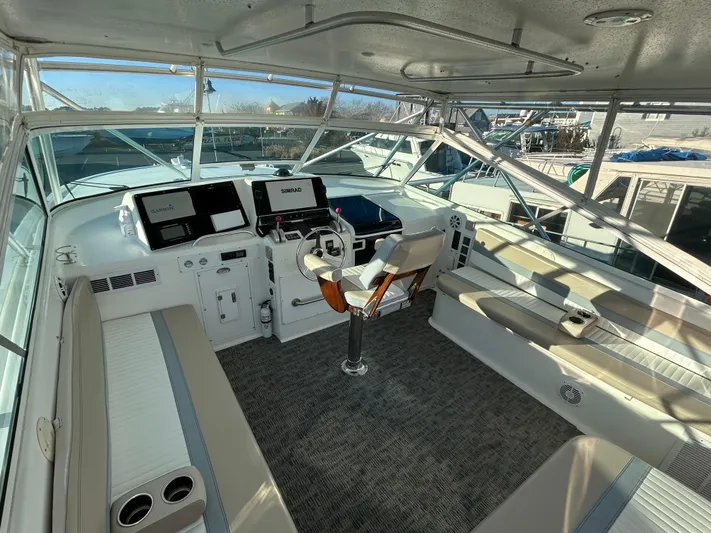 Bad Habit Yacht Photos Pics 1997 Viking 43 Open yacht cockpit with modern navigation equipment and seating.