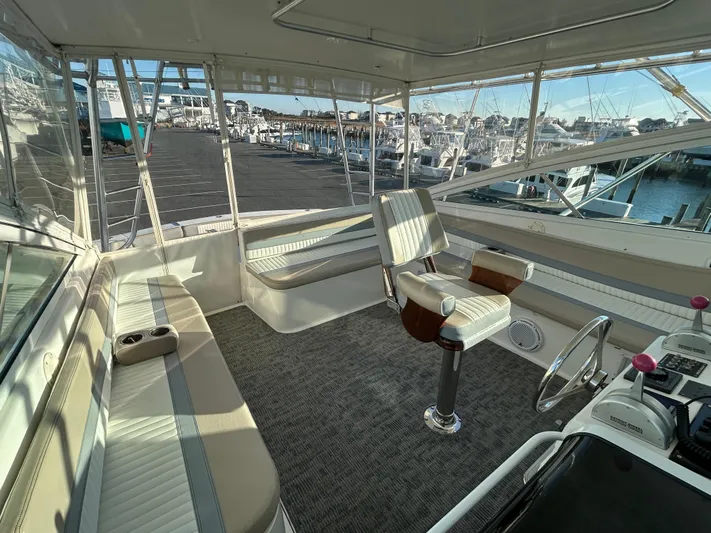 Bad Habit Yacht Photos Pics 1997 Viking 43 Open yacht interior with helm and seating area, docked at marina.