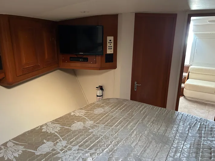 Bad Habit Yacht Photos Pics Cozy bedroom in 1997 Viking 43 Open yacht with TV and wooden cabinets.