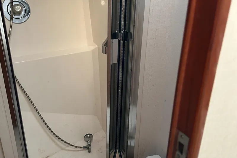 Bad Habit Yacht Photos Pics Shower area in 1997 Viking 43 Open boat with sliding door.