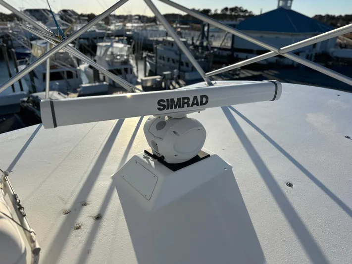 Bad Habit Yacht Photos Pics Simrad radar on 1997 Viking 43 Open boat, marina background.