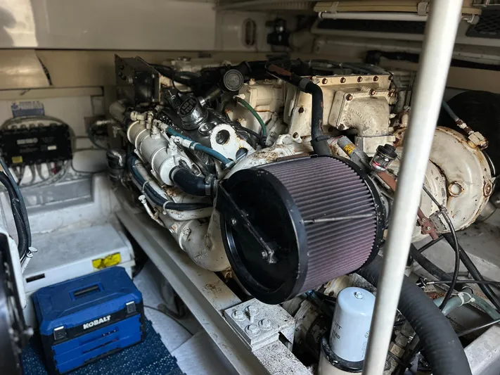 Bad Habit Yacht Photos Pics Engine room of 1997 Viking 43 Open boat with visible components and tools.