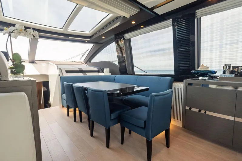 Ocean's Se7en Yacht Photos Pics Luxurious interior of 2022 Azimut S8 yacht with elegant dining area and panoramic windows.