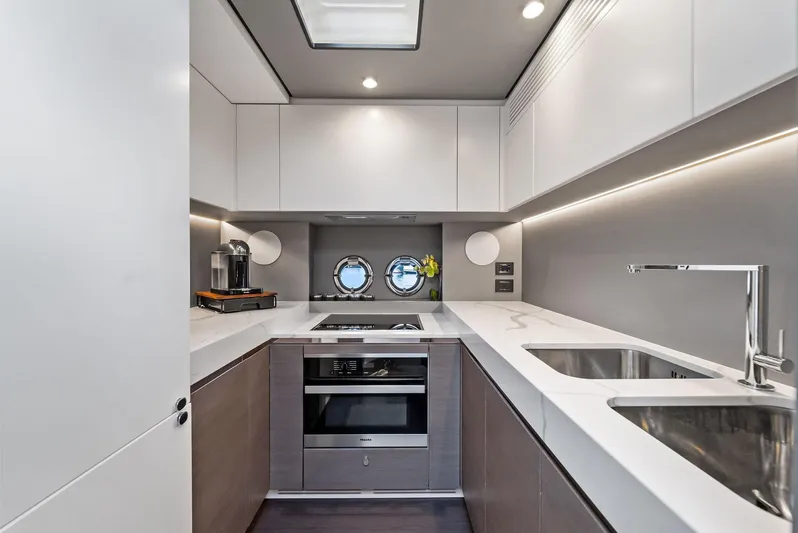 Ocean's Se7en Yacht Photos Pics Modern kitchen interior on 2022 Azimut S8 yacht, featuring sleek design and dual sinks.