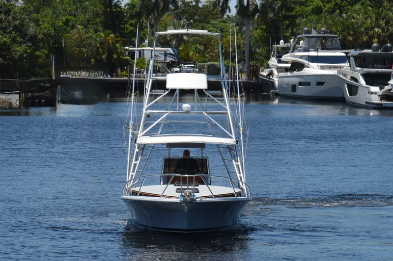  Yacht Photos Pics 2023 Strike 29 boat cruising on a calm waterway with yachts in the background.