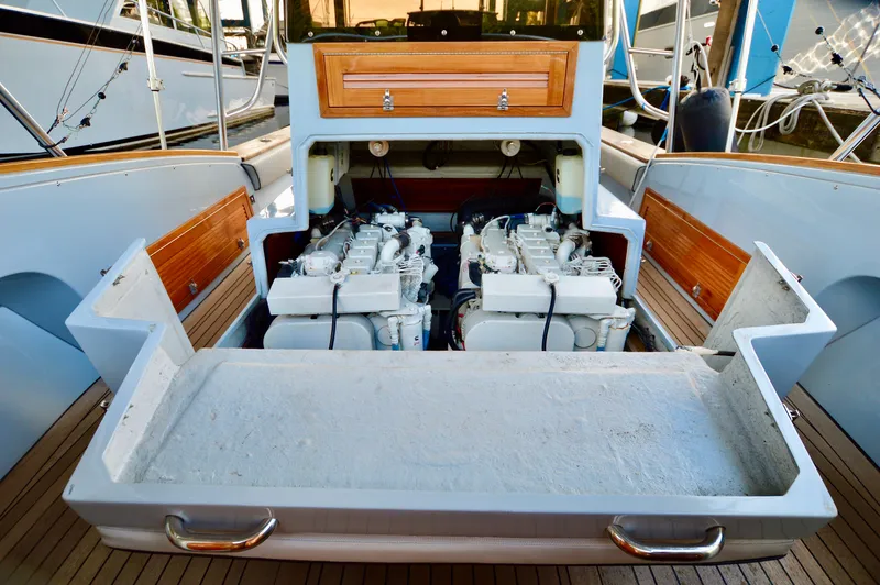 Yacht Photos Pics 2023 Strike 29 boat engine compartment with dual engines and wooden accents.