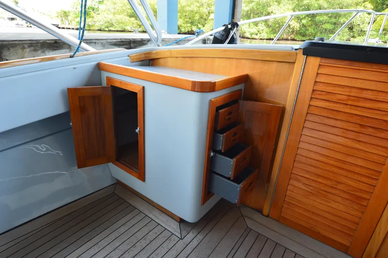  Yacht Photos Pics 2023 Strike 29 boat interior with wooden cabinets and drawers, featuring open storage.