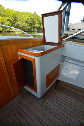  Yacht Photos Pics 2023 Strike 29 boat interior with wooden cabinetry and open storage compartments.