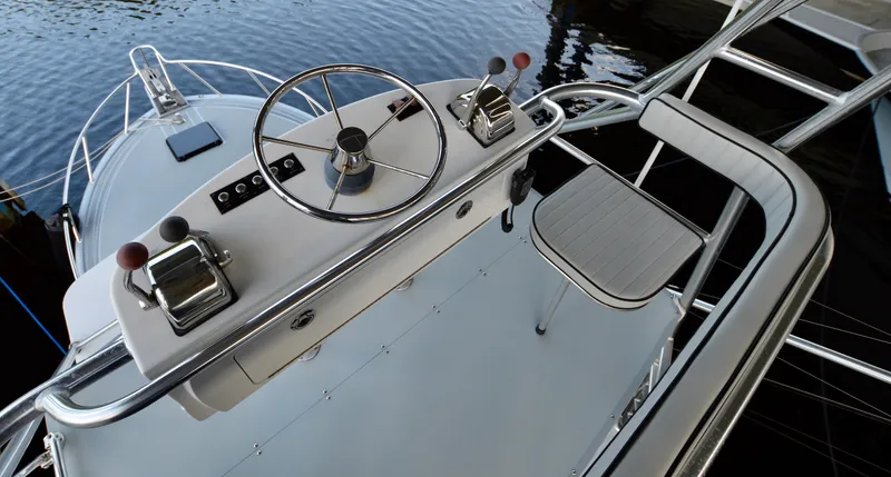  Yacht Photos Pics 2023 Strike 29 boat helm with steering wheel and controls, docked on calm water.