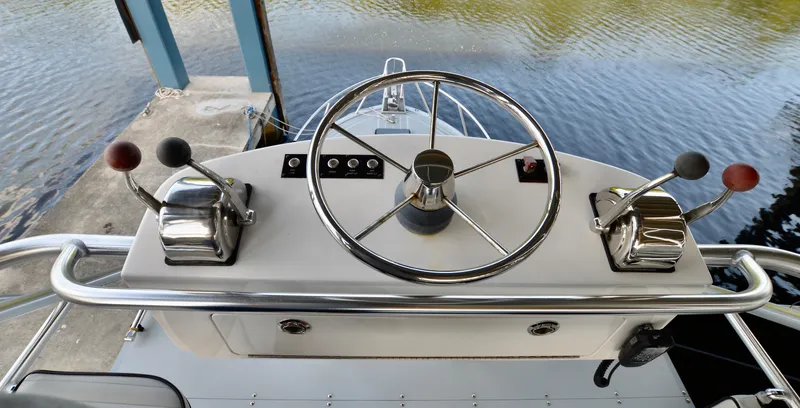  Yacht Photos Pics Helm of 2023 Strike 29 boat with dual throttle controls and steering wheel.