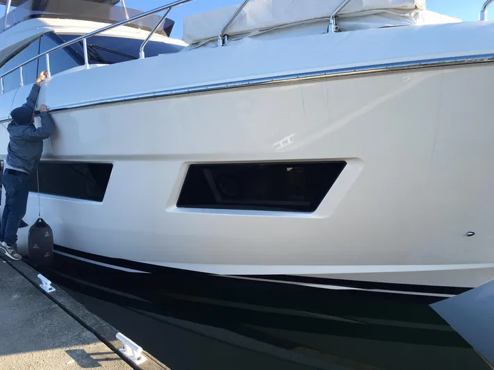  Yacht Photos Pics 2018 Ferretti Yachts 670 docked, side view with person adjusting fender.