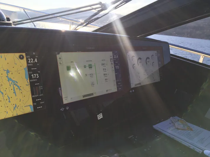  Yacht Photos Pics Cockpit of 2018 Ferretti Yachts 670 with navigation screens and sunlight streaming through.