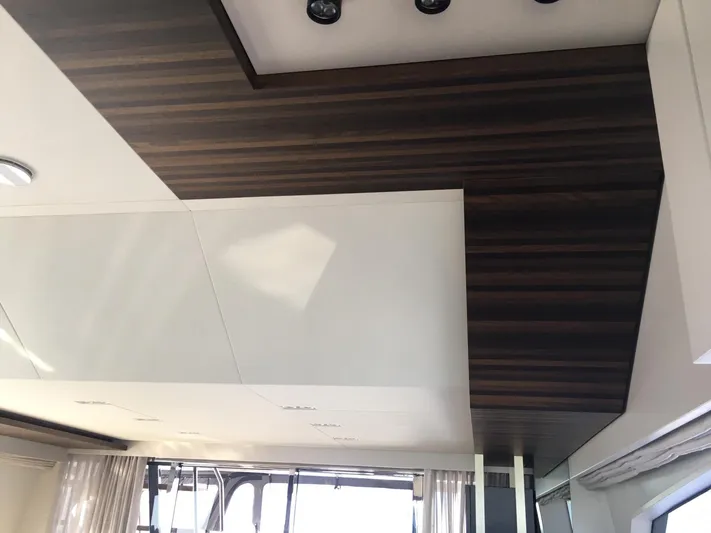  Yacht Photos Pics Luxurious interior ceiling of 2018 Ferretti Yachts 670 with modern wood and white paneling.