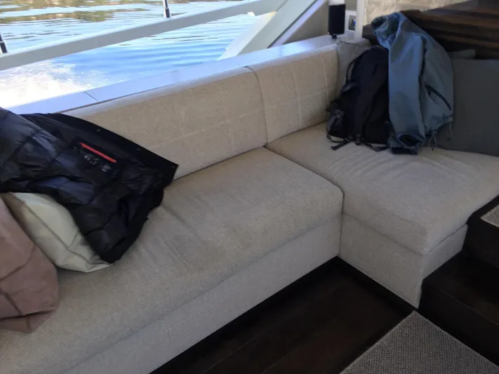  Yacht Photos Pics Luxurious seating area on 2018 Ferretti Yachts 670 with jackets and bags.