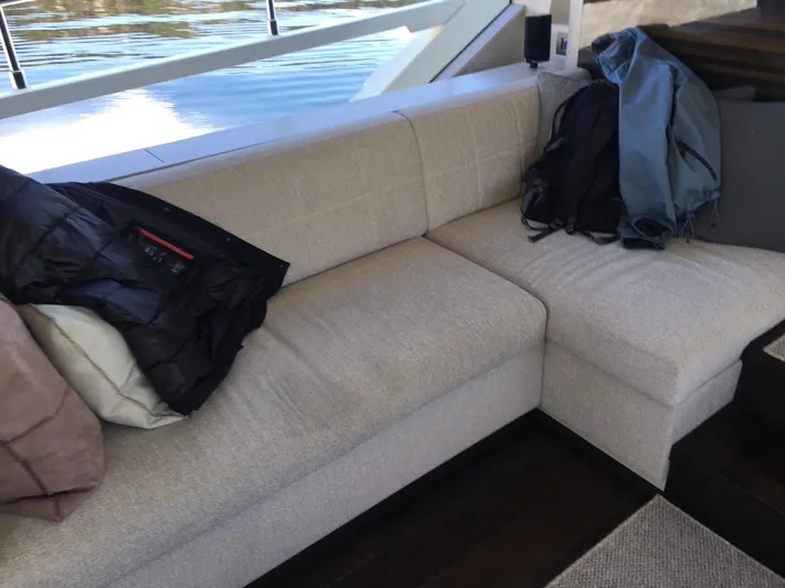  Yacht Photos Pics Luxurious interior seating on a 2018 Ferretti Yachts 670, featuring a beige sofa with jackets.