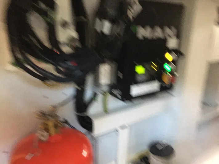  Yacht Photos Pics Blurry image of Ferretti Yachts 670 engine room with control panel and fire extinguisher.