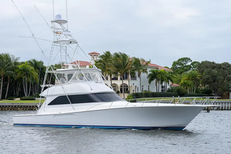  Yacht Photos Pics 2005 Viking 61 yacht cruising near waterfront mansion with palm trees.