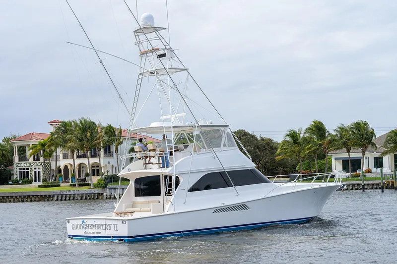 Yacht Photos Pics 2005 Viking 61 yacht cruising near waterfront homes with palm trees.