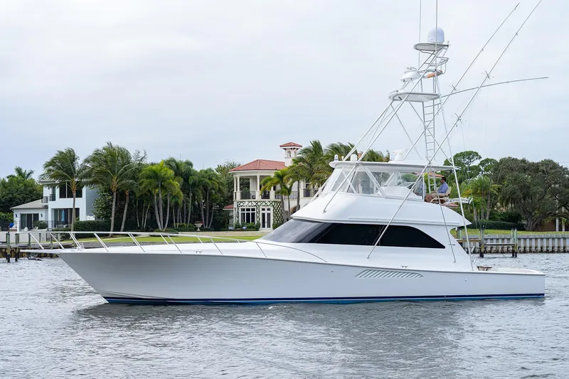  Yacht Photos Pics 2005 Viking 61 yacht cruising near waterfront homes with palm trees.