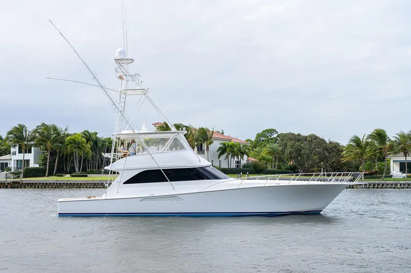  Yacht Photos Pics 2005 Viking 61 yacht cruising near waterfront homes with palm trees.