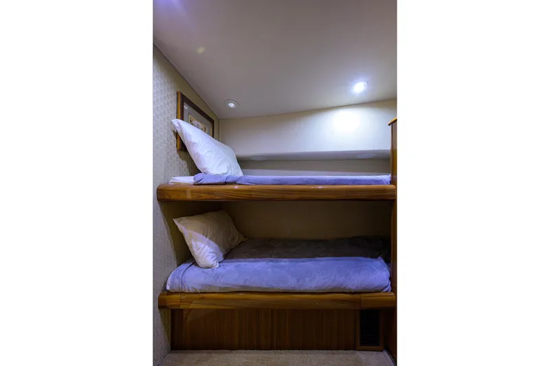  Yacht Photos Pics Bunk beds in 2005 Viking 61 yacht cabin with soft lighting and cozy bedding.