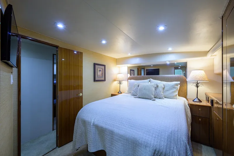  Yacht Photos Pics Luxurious bedroom interior of 2005 Viking 61 yacht with elegant lighting and decor.