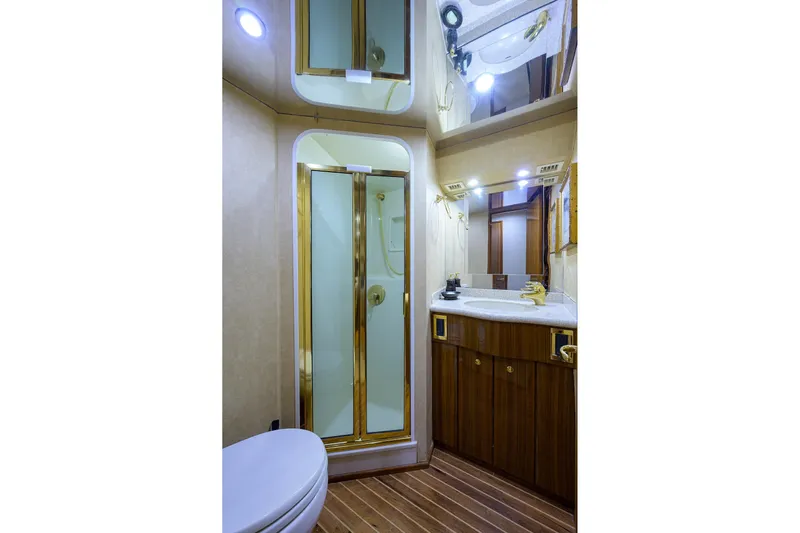  Yacht Photos Pics Luxurious bathroom in 2005 Viking 61 yacht with wood accents and modern fixtures.