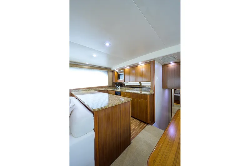  Yacht Photos Pics Luxurious interior of 2005 Viking 61 yacht with wooden cabinetry and granite countertops.